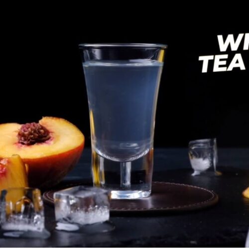 White tea shot with half lemon serves on vodka
