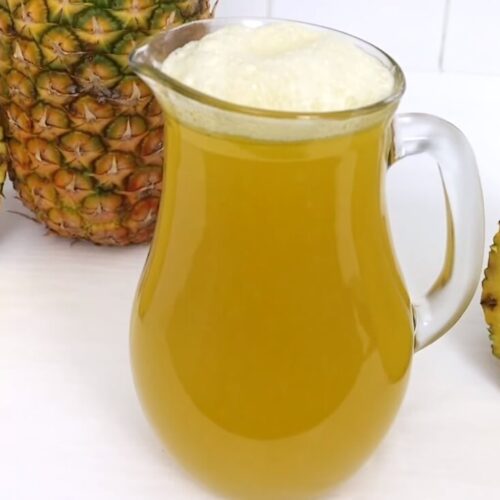 Fireball and Pineapple Juice Tiktok trends recipe image with pineaaple slice and jug